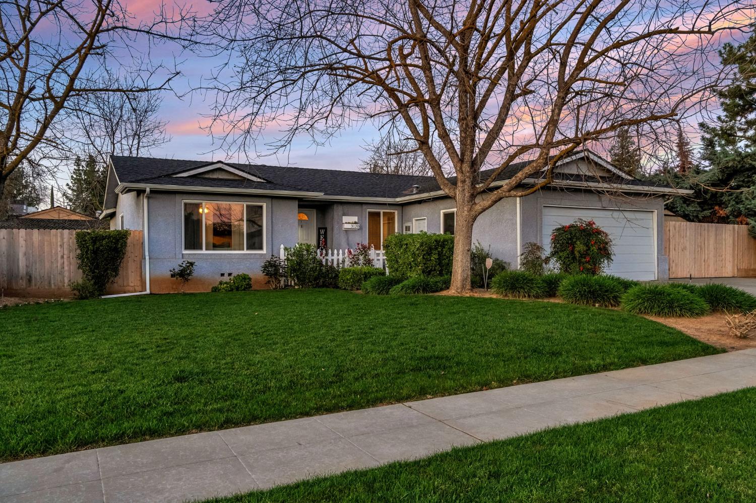 3120 West San Ramon Avenue Fresno, CA 93711 - Photo 2 of 36 a front view of house with yard and green space