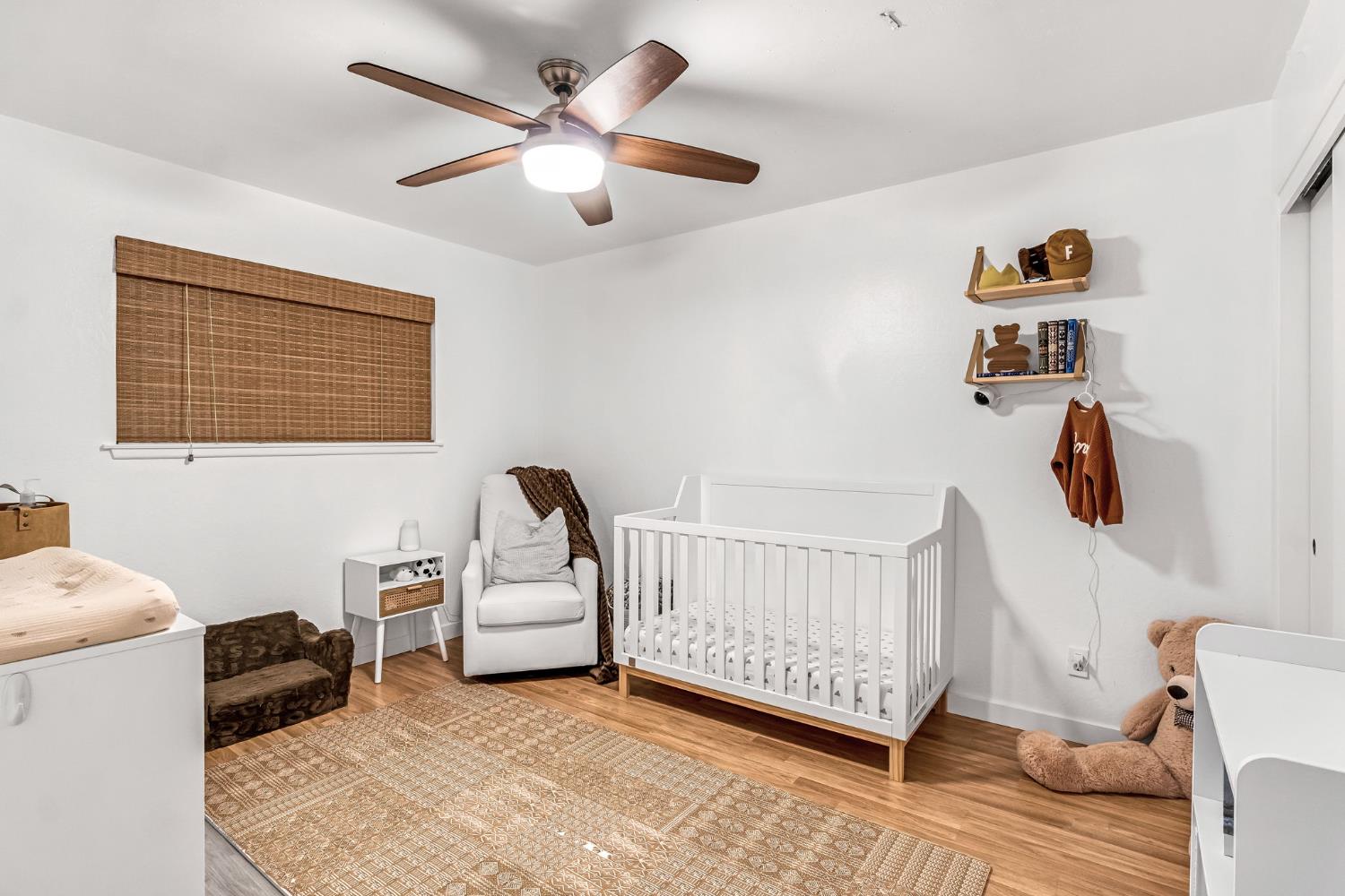 3120 West San Ramon Avenue Fresno, CA 93711 - Photo 21 of 36 a view of a bedroom with furniture and a ceiling fan