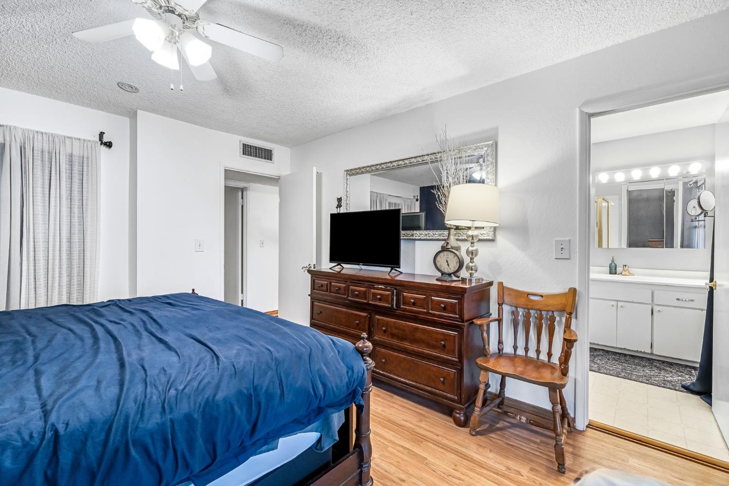 3120 West San Ramon Avenue Fresno, CA 93711 - Photo 24 of 36 a bedroom with a bed and a flat screen tv
