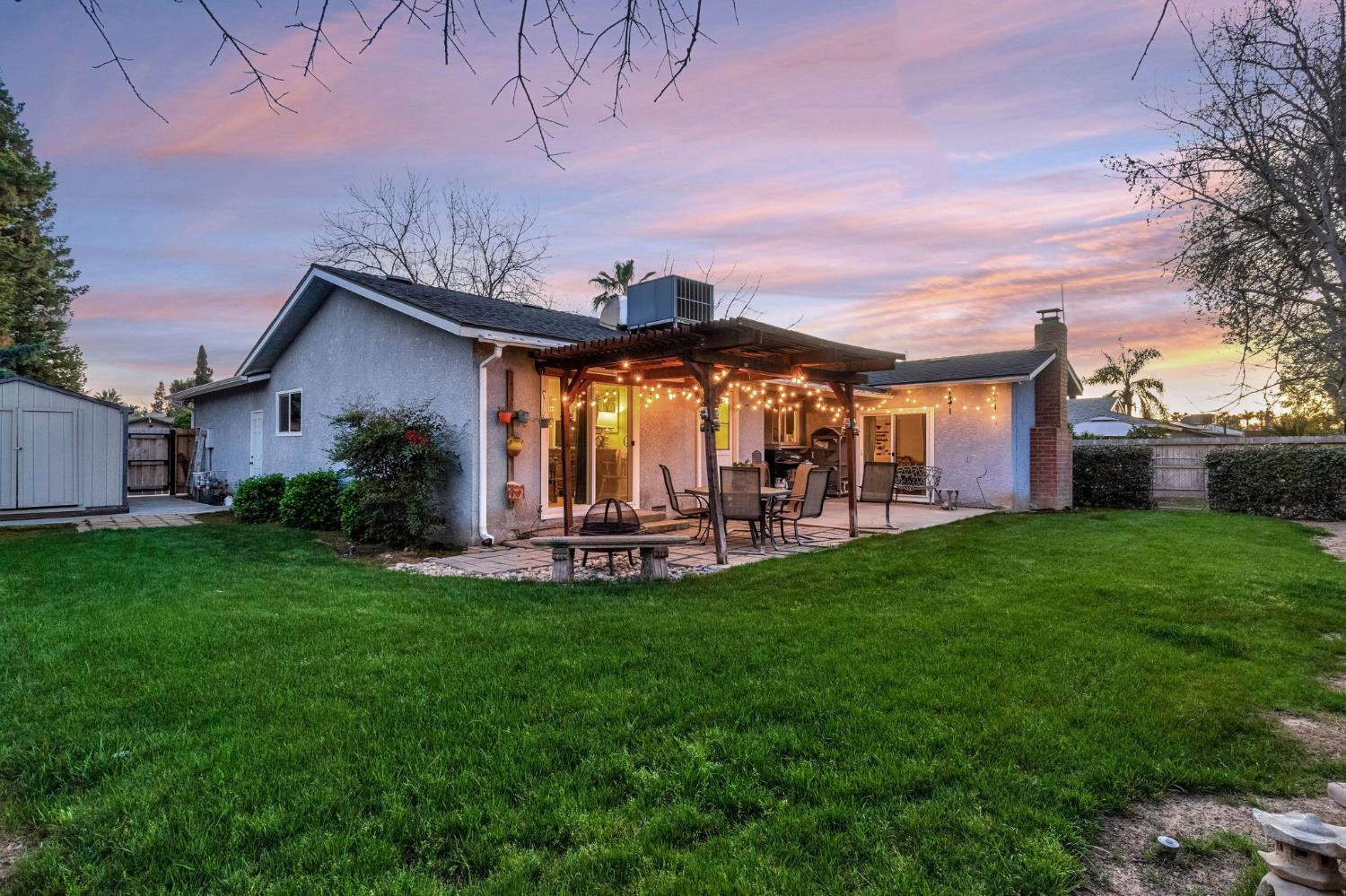 3120 West San Ramon Avenue Fresno, CA 93711 - Photo 29 of 36 a view of a house with backyard sitting area and garden