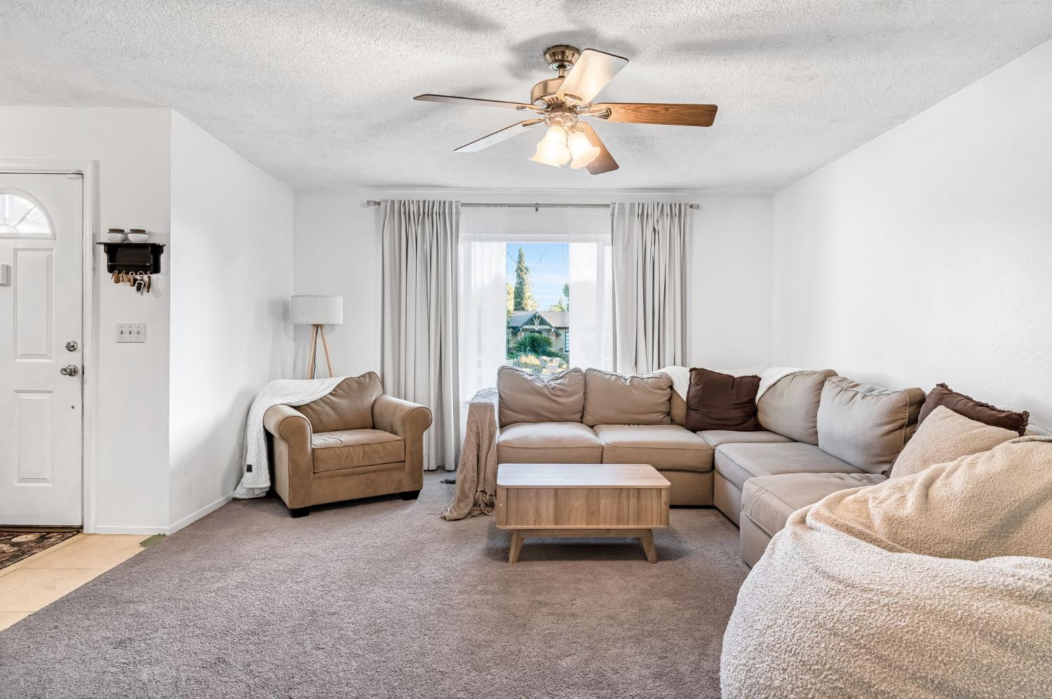 3120 West San Ramon Avenue Fresno, CA 93711 - Photo 6 of 36 a living room with furniture and a large window