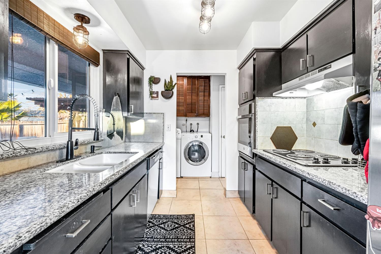 3120 West San Ramon Avenue Fresno, CA 93711 - Photo 10 of 36 a kitchen with stainless steel appliances granite countertop a sink and cabinets