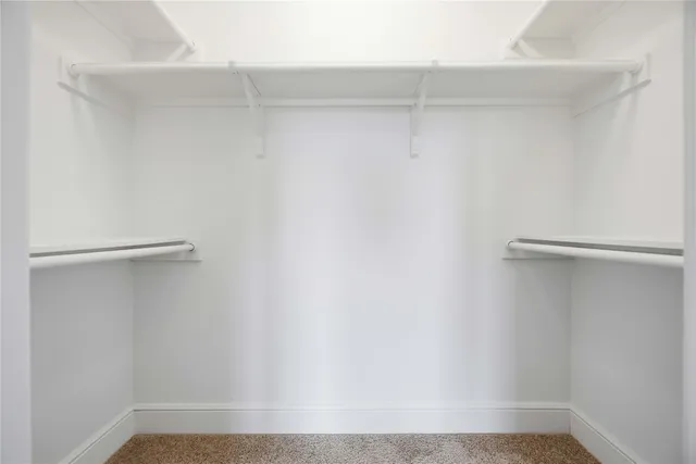 a spacious bathroom with a double vanity sink mirror and shower
