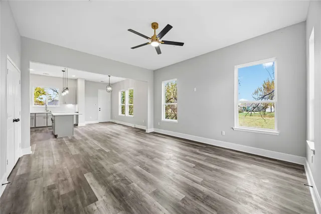 a view of a livingroom with a hardwood floor and a ceiling fan