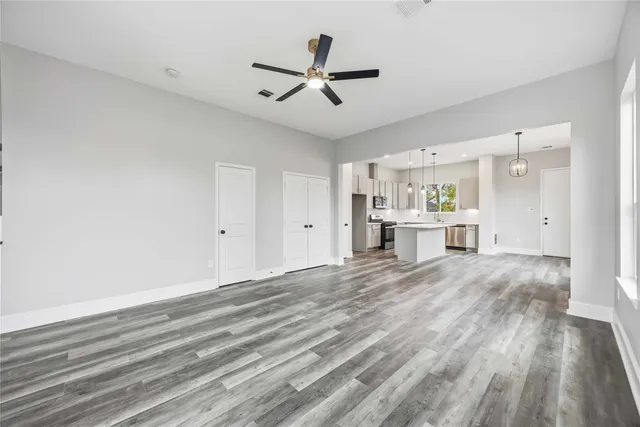 a view of a livingroom with a hardwood floor and a ceiling fan