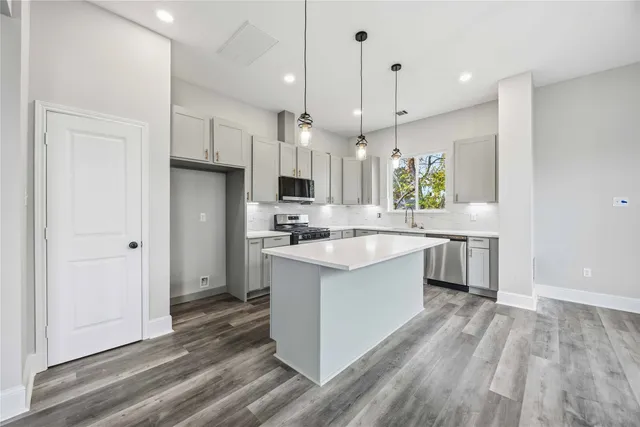 a large kitchen with a lot of counter space and a sink