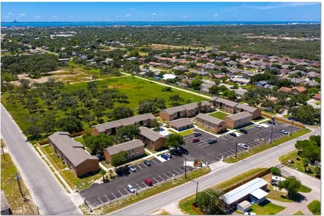 an aerial view of residential houses with outdoor space