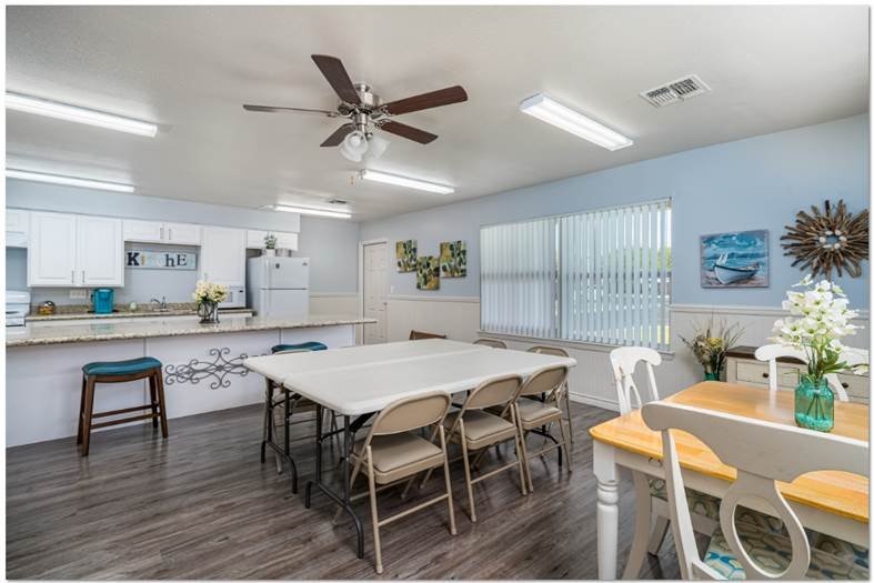 200 South Ave A, Unit 50 Aransas Pass, TX 78336 - Photo 3 of 14 a view of a dining room with furniture and wooden floor