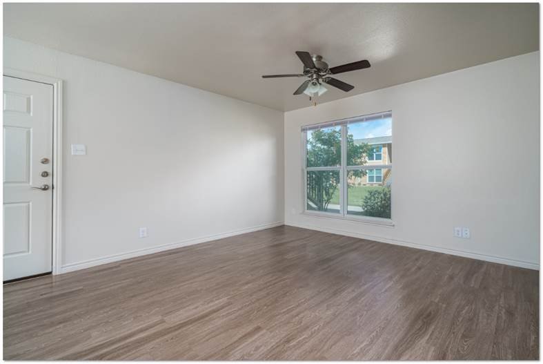 200 South Ave A, Unit 50 Aransas Pass, TX 78336 - Photo 6 of 14 a view of a big room with wooden floor and windows