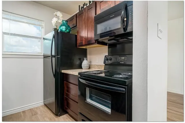 a kitchen with a refrigerator stove and microwave