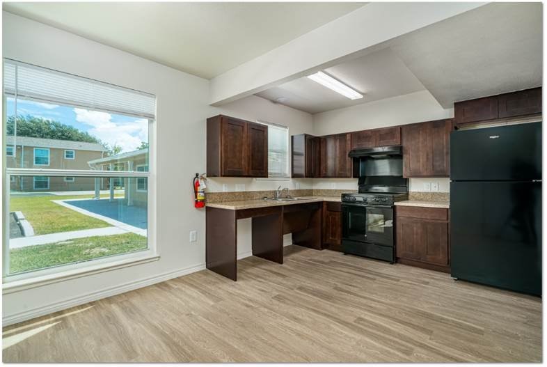 200 South Ave A, Unit 50 Aransas Pass, TX 78336 - Photo 10 of 14 a kitchen with a refrigerator and a stove