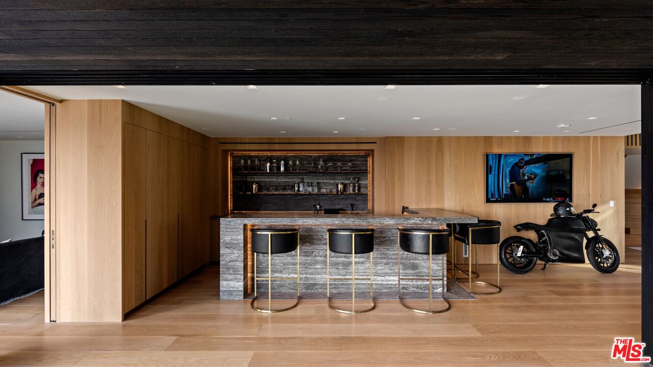 1663 Summitridge Drive Beverly Hills, CA 90210 - Photo 12 of 41 a view of a room with wooden floor and furniture