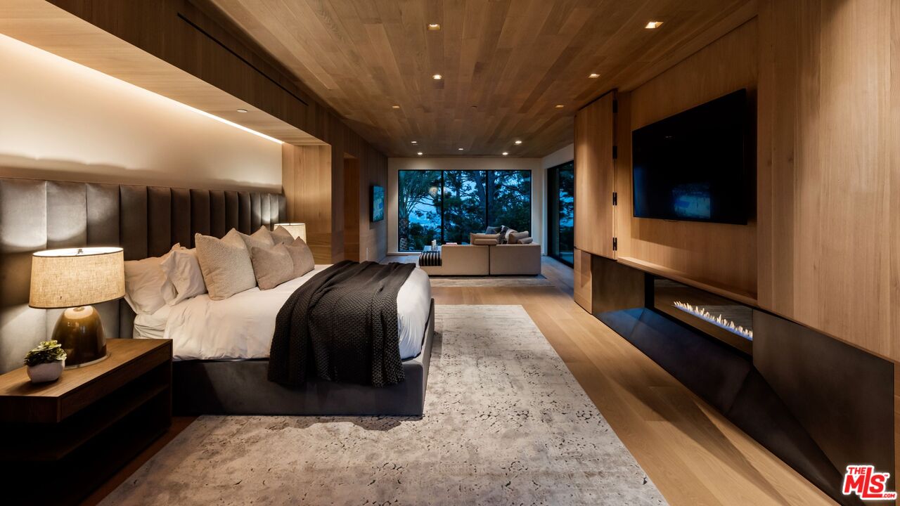 1663 Summitridge Drive Beverly Hills, CA 90210 - Photo 24 of 41 a living room with furniture and a flat screen tv