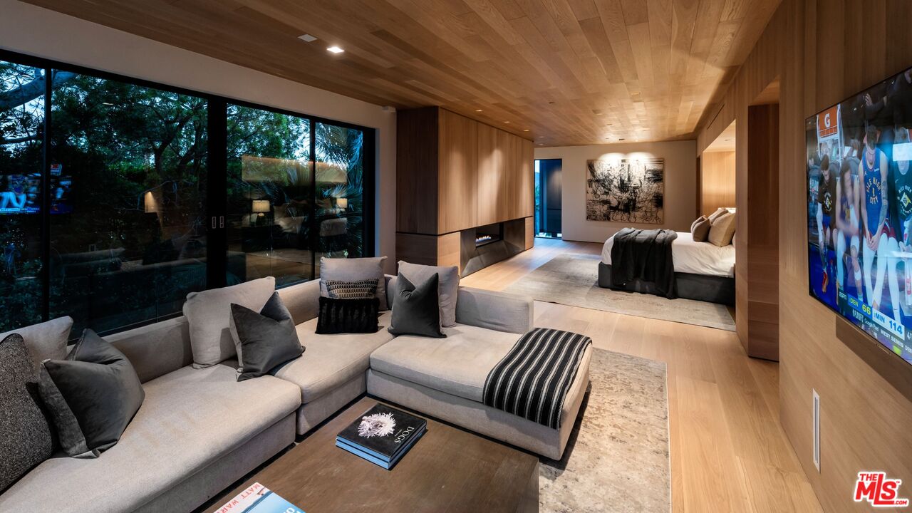 1663 Summitridge Drive Beverly Hills, CA 90210 - Photo 26 of 41 a living room with furniture and a large window