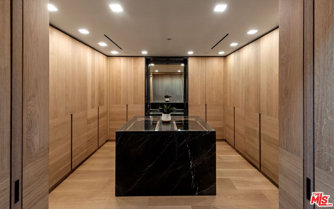 1663 Summitridge Drive Beverly Hills, CA 90210 - Photo 28 of 41 a bathroom with a sink and a mirror