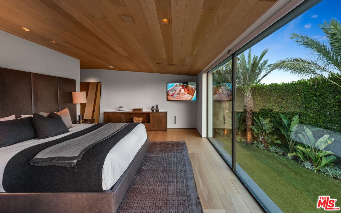 1663 Summitridge Drive Beverly Hills, CA 90210 - Photo 33 of 41 a bed room with a bed and a view of balcony