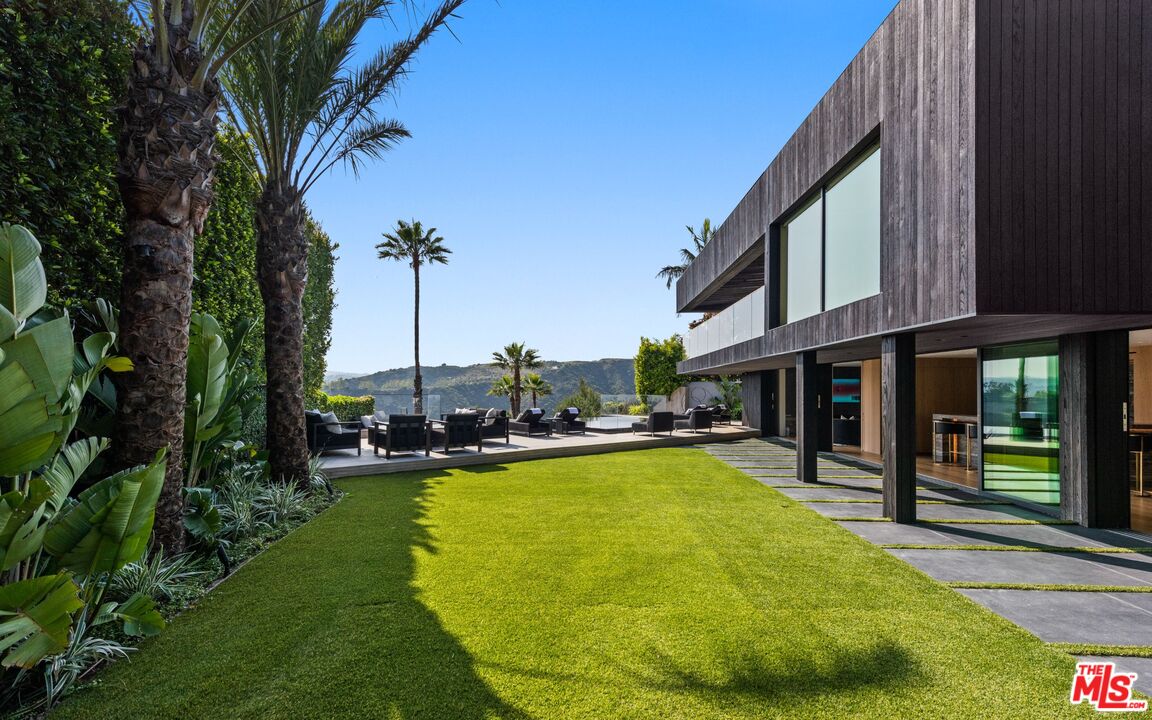 1663 Summitridge Drive Beverly Hills, CA 90210 - Photo 40 of 41 a view of a swimming pool with a lounge chairs