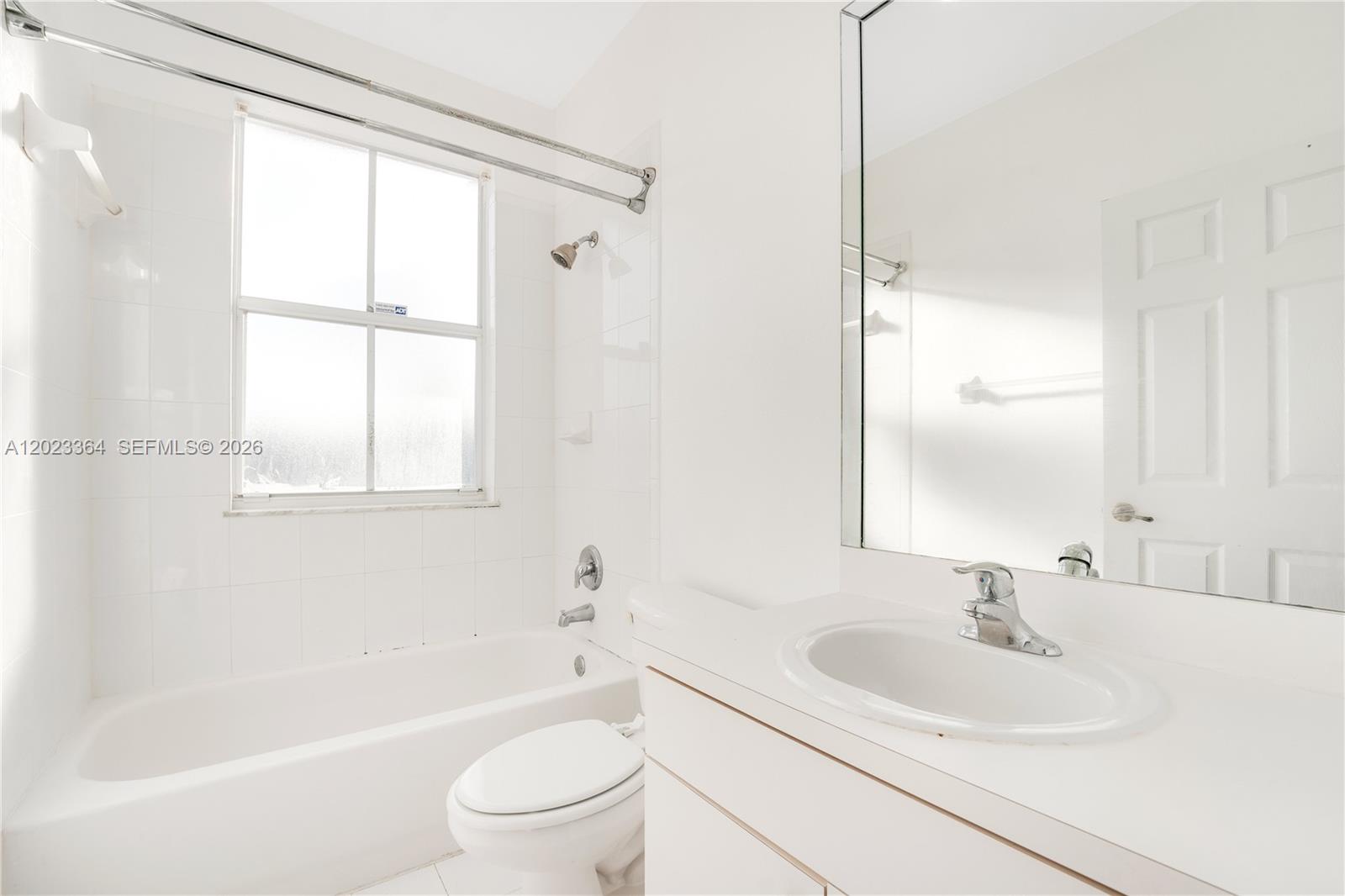 27433 Southwest 137th Court, Unit 1 Homestead, FL 33032 - Photo 13 of 28 a bathroom with a sink toilet and shower
