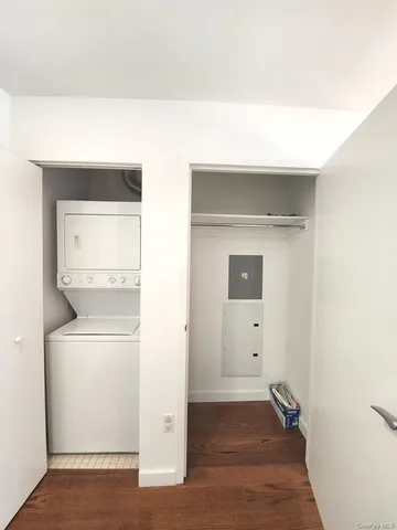 a view of a hallway with wooden floor and a sink