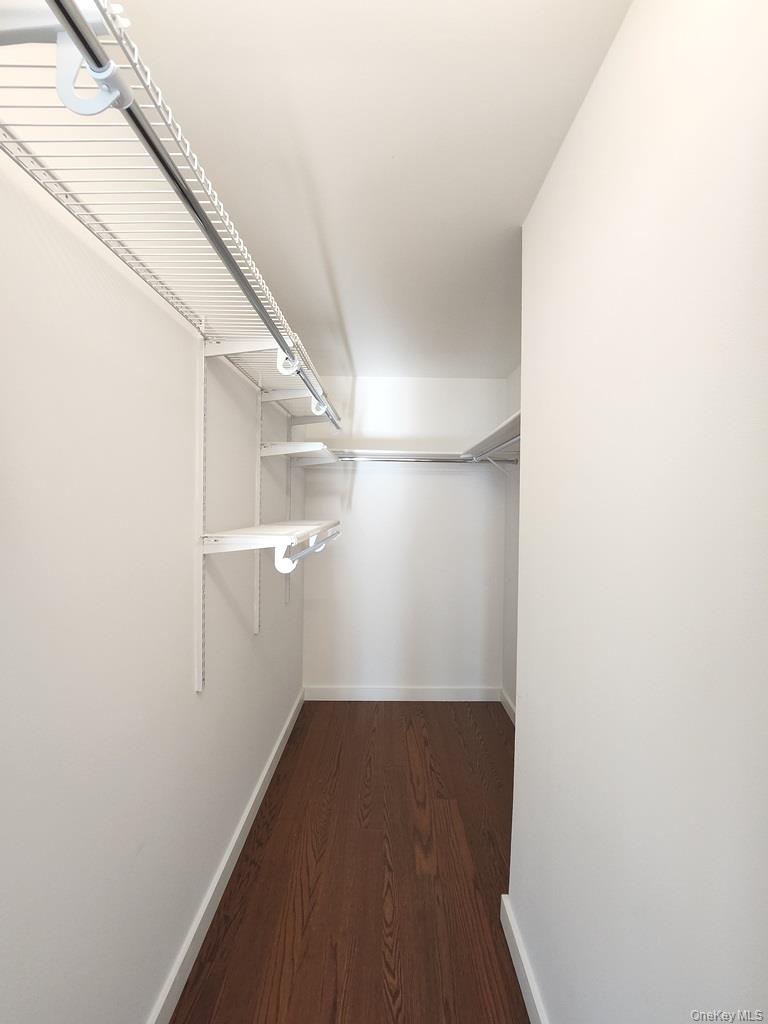 40-26 College Point Boulevard, Unit 18K Queens, NY 11354 - Photo 7 of 16 a view of a hallway with wooden floor