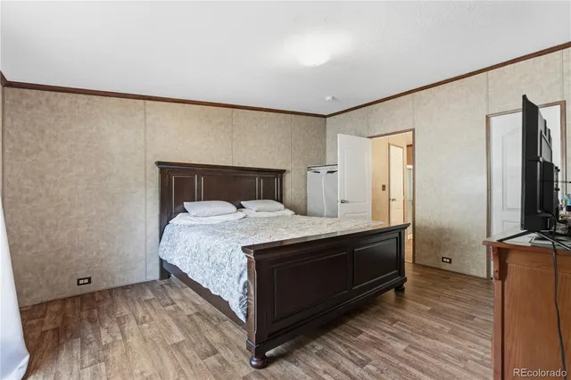 a bed room with a bed and a television