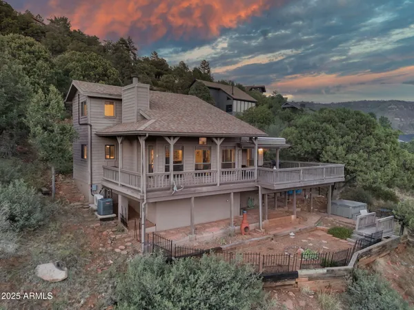 an aerial view of a house with a yard balcony