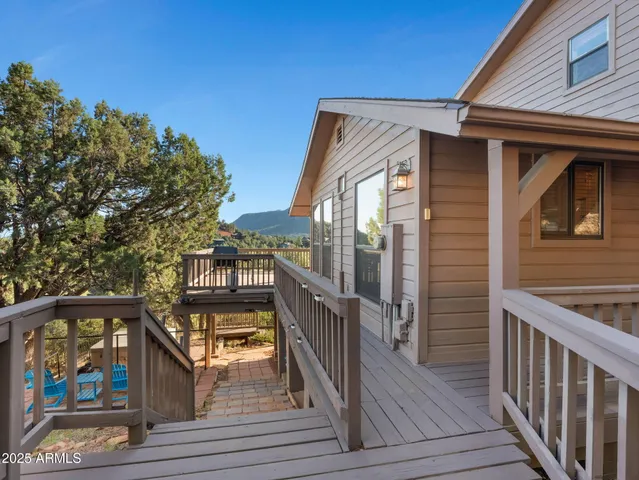 a view of a balcony with wooden floor and outdoor seating