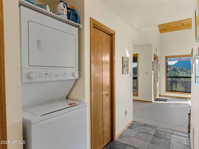 a kitchen with stainless steel appliances granite countertop a refrigerator sink stove and white cabinets