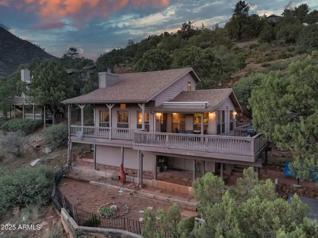 a aerial view of a house with a yard balcony and furniture