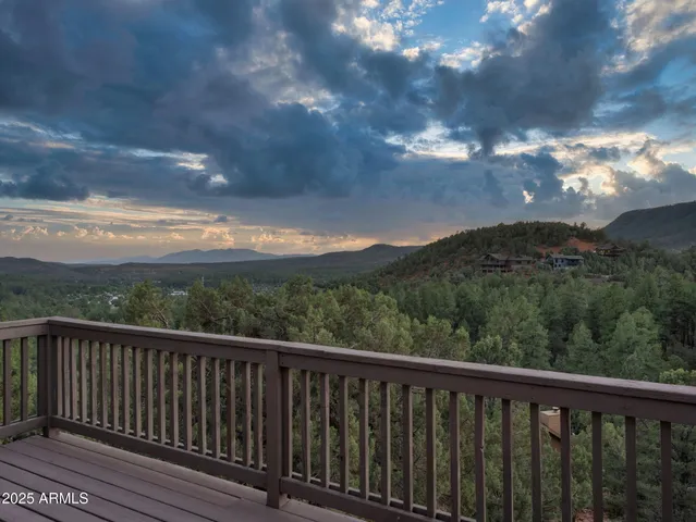 a view of a balcony with wooden fence