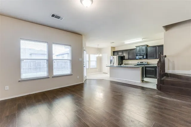 a view of a kitchen with a sink wooden floor and a window
