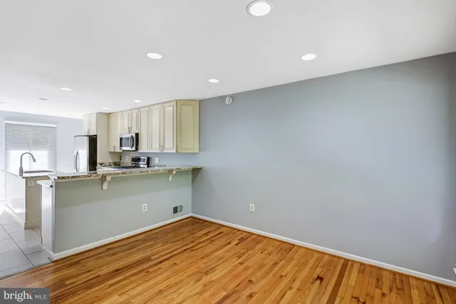 a kitchen with a refrigerator and a sink