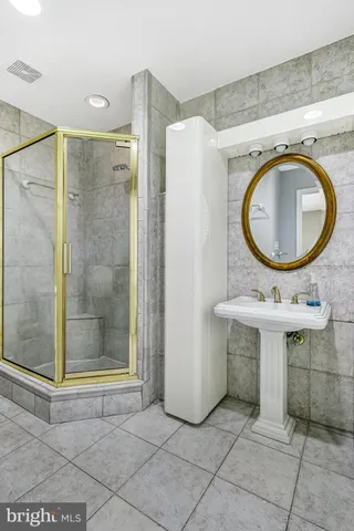 a bathroom with a sink a toilet and a shower