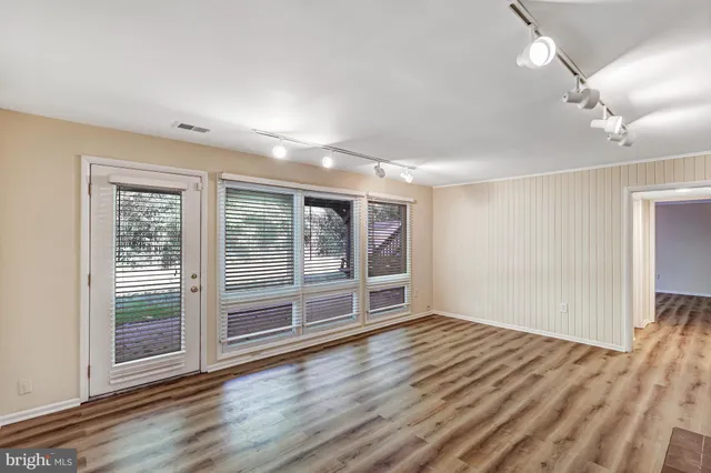 a view of wooden floor and windows in a room