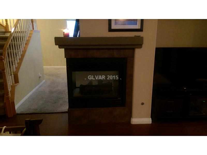 9064 Rusty Rifle Avenue Las Vegas, NV 89143 - Photo 4 of 24 Property Photo. Cozy fireplace in family room
