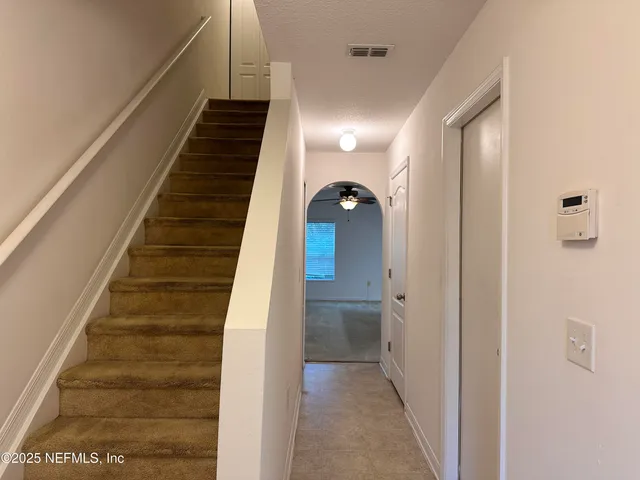 a view of entryway and hall with wooden floor