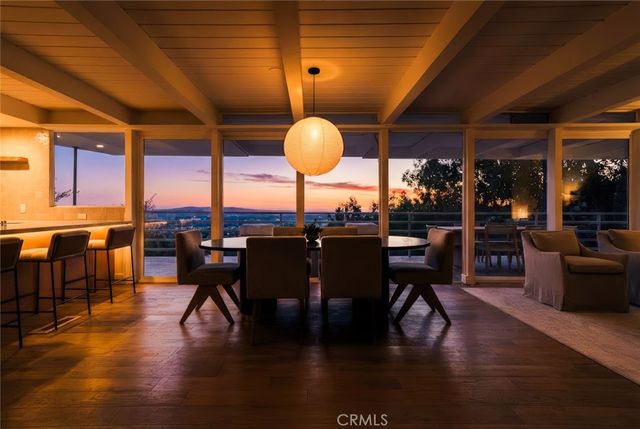 a view of a dining room with furniture wooden floor and chandelier