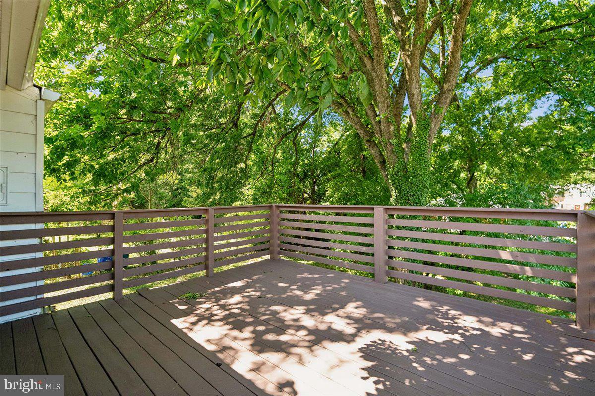 13012 Georgia Avenue Silver Spring, MD 20906 - Photo 28 of 31 Serene deck embraced by lush greenery.