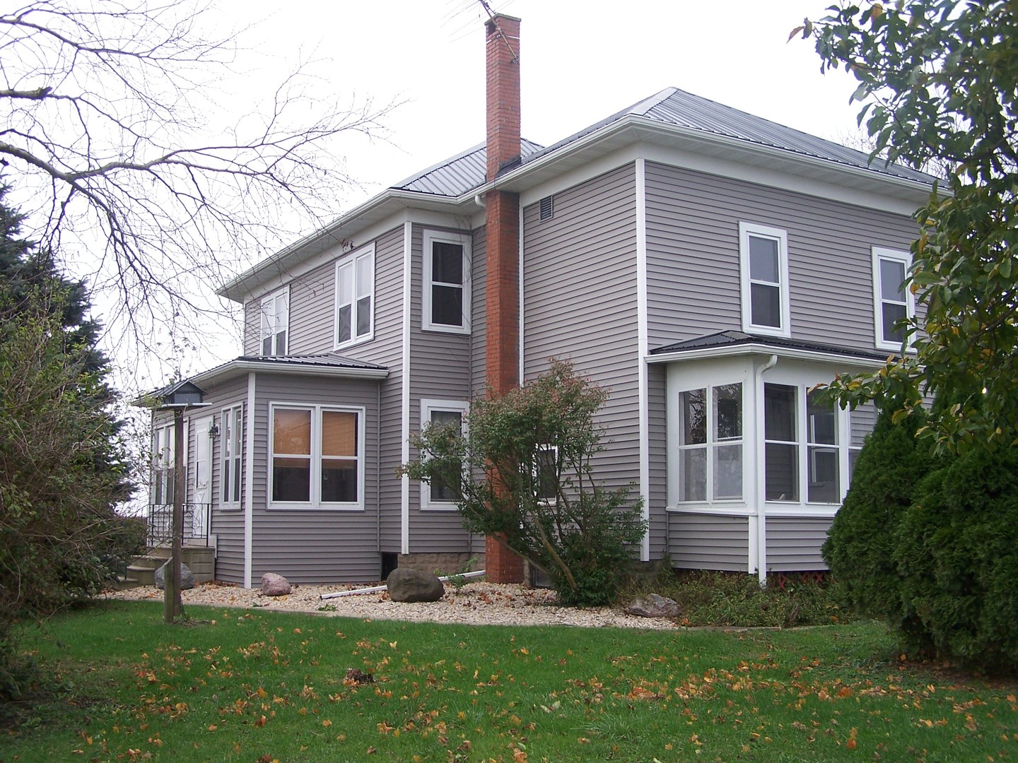 4045 East 22nd Road Serena, IL 60549 - Photo 1 of 31 a front view of a house with a yard and trees
