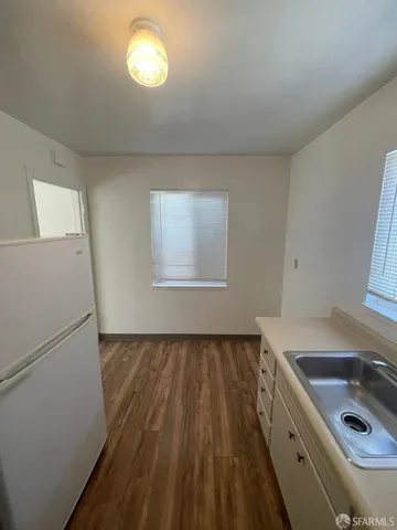a bathroom with a sink a toilet a tub and mirror