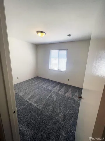 a kitchen with granite countertop a stove and a refrigerator