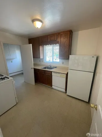 a bathroom with a double vanity sink toilet and mirror