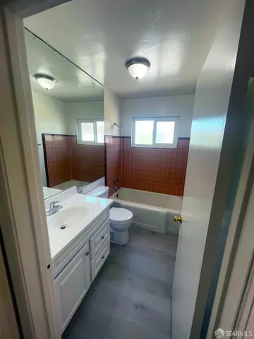 a view of a house with backyard and parking