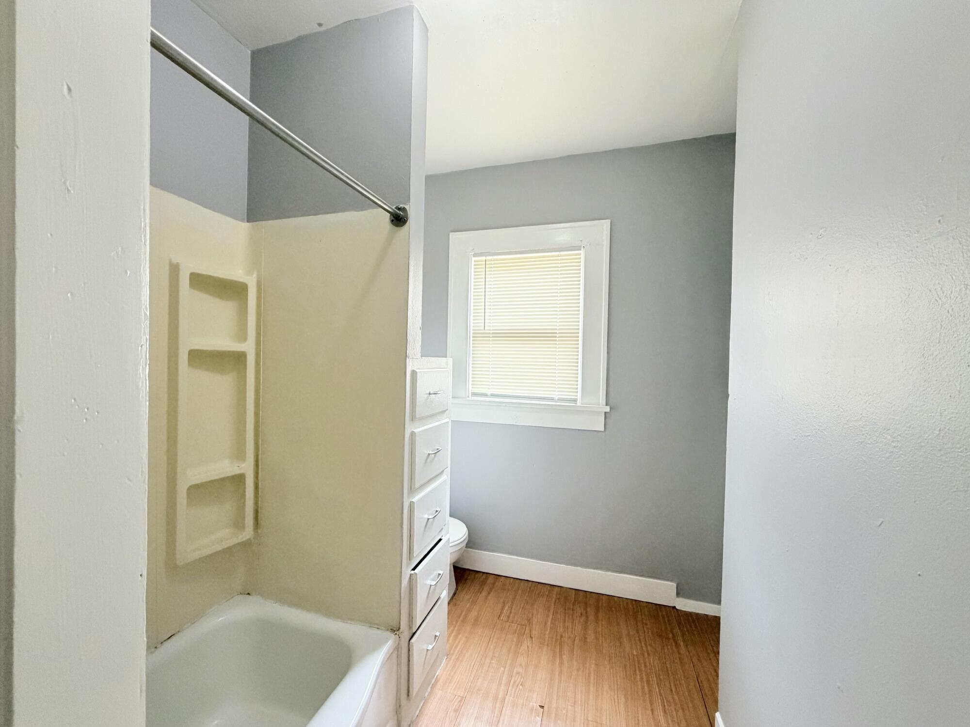 2119 15th Street Lubbock, TX 79401 - Photo 12 of 15 a bathroom with a tub and shower