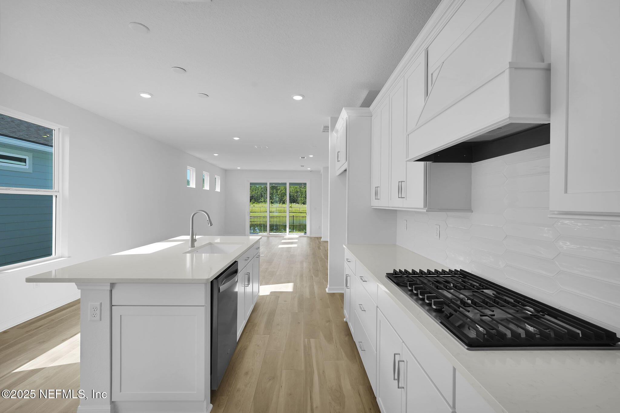 239 Fairlake Circle St. Augustine, FL 32092 - Photo 11 of 30 a kitchen with granite countertop a sink stove and cabinets