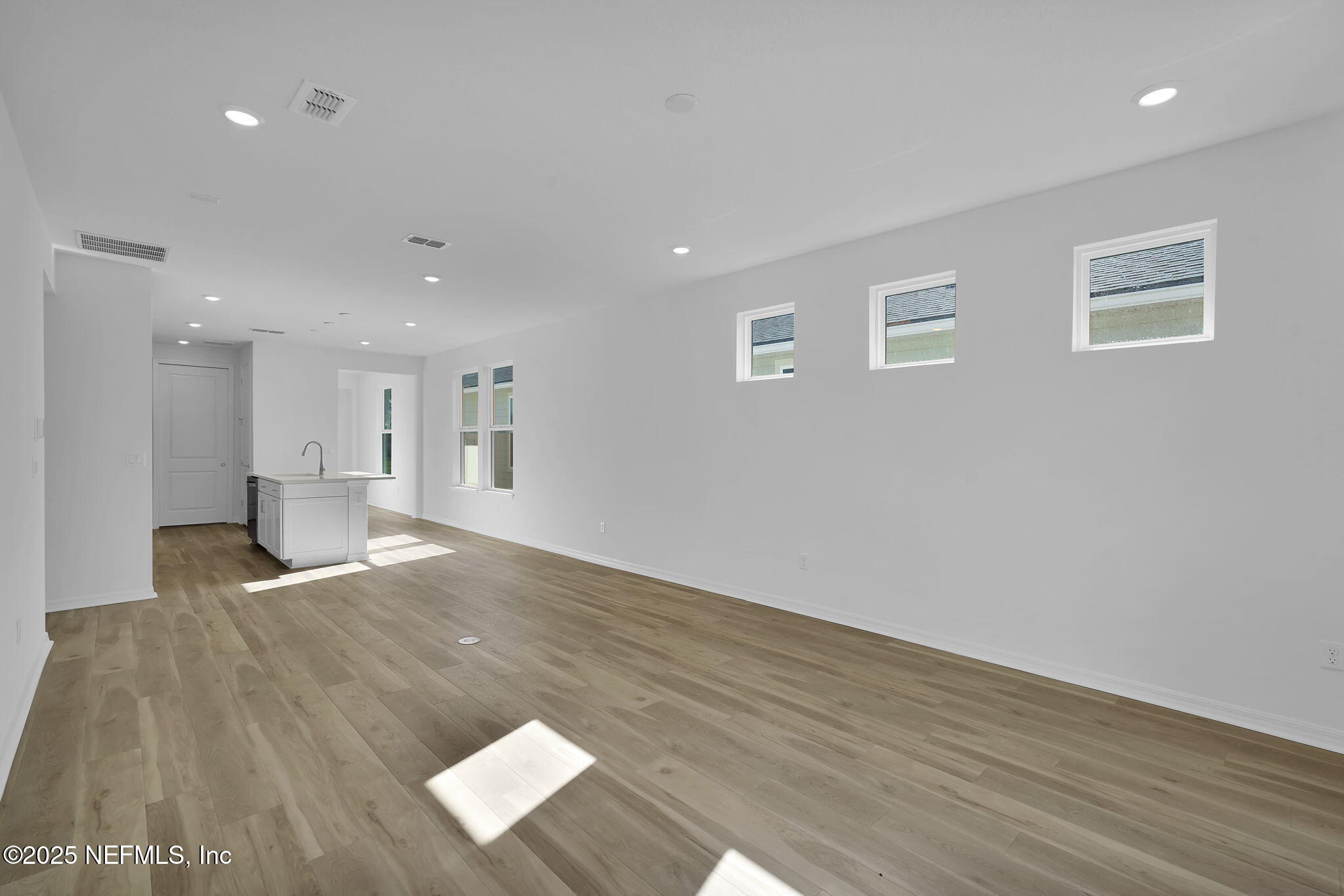 239 Fairlake Circle St. Augustine, FL 32092 - Photo 14 of 30 a view of an empty room with wooden floor and a window