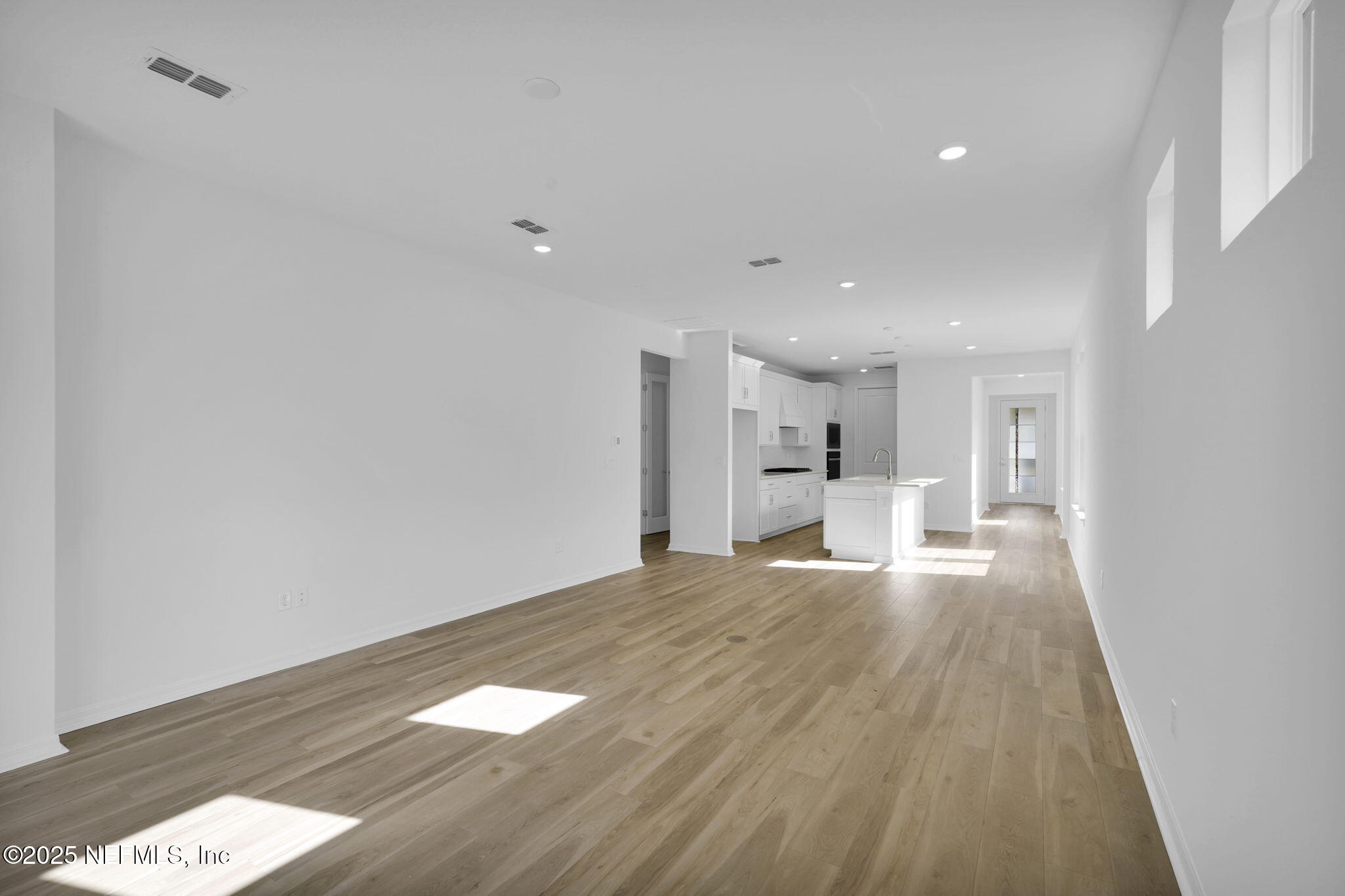 239 Fairlake Circle St. Augustine, FL 32092 - Photo 16 of 30 a view of a big room with wooden floor and a window