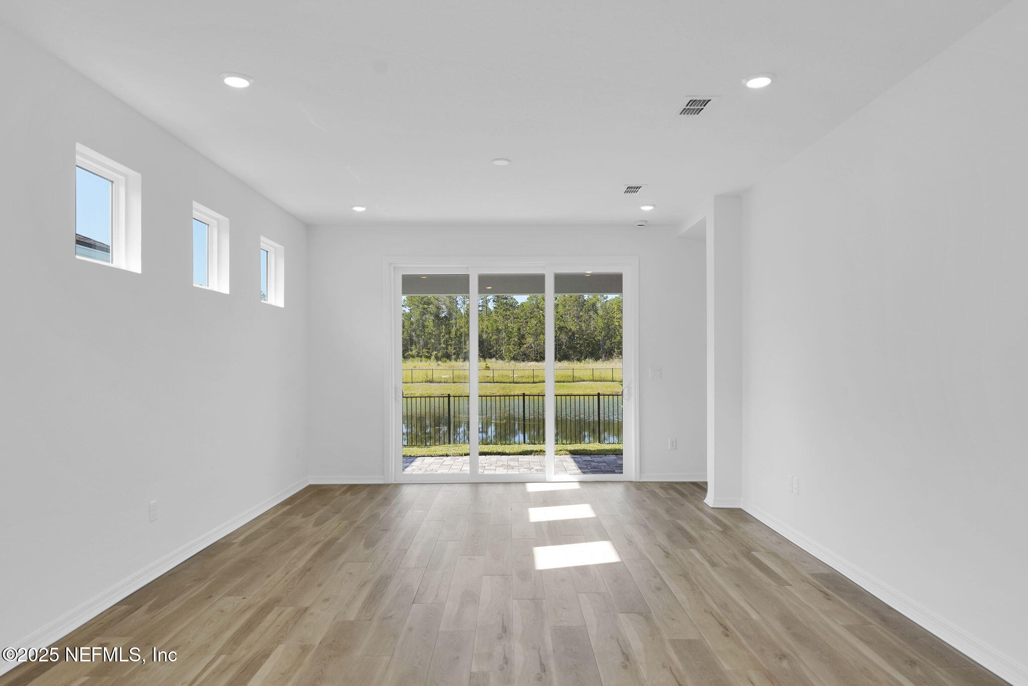 239 Fairlake Circle St. Augustine, FL 32092 - Photo 17 of 30 a view of empty room with wooden floor and fan