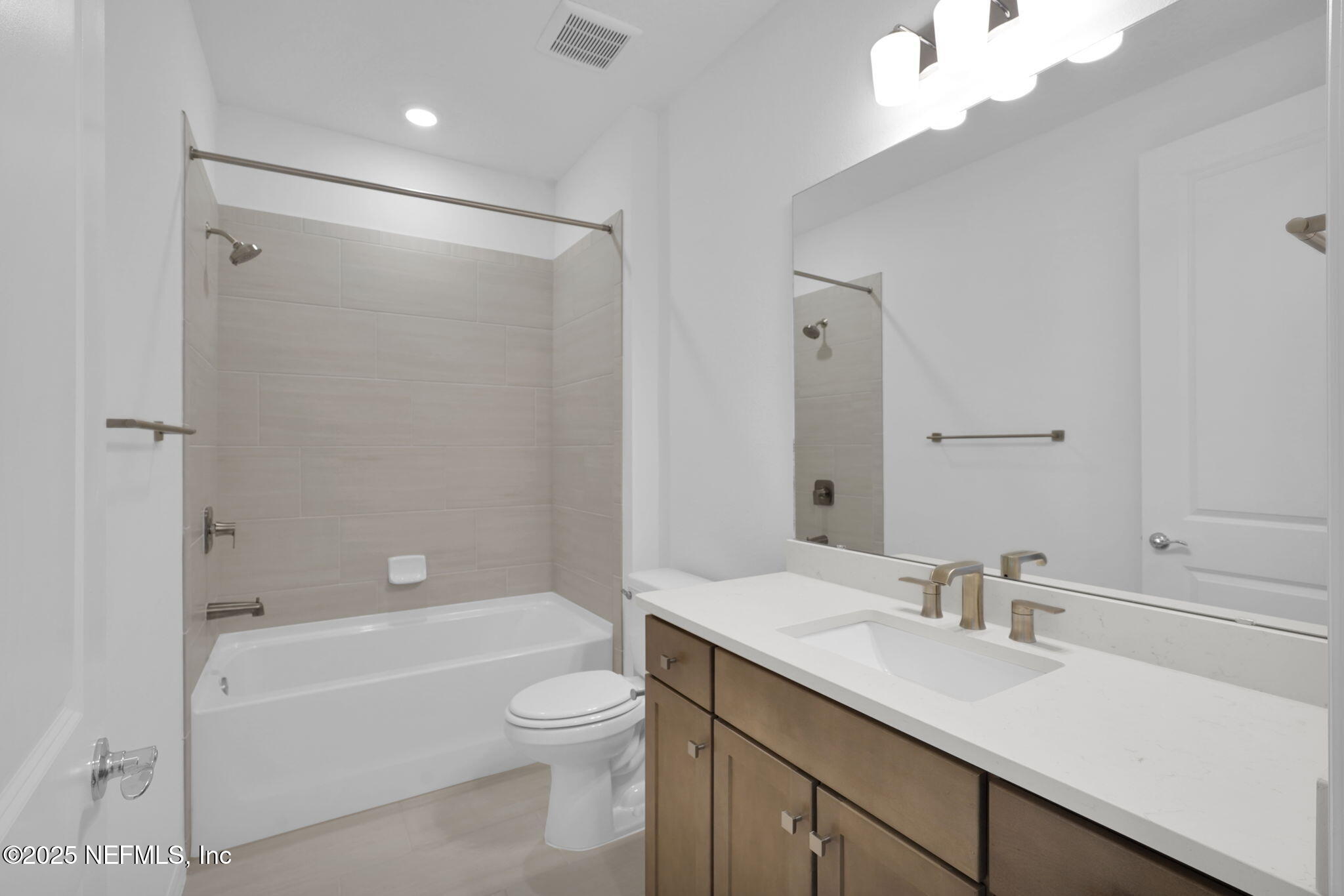 239 Fairlake Circle St. Augustine, FL 32092 - Photo 20 of 30 a bathroom with a granite countertop sink a toilet and shower