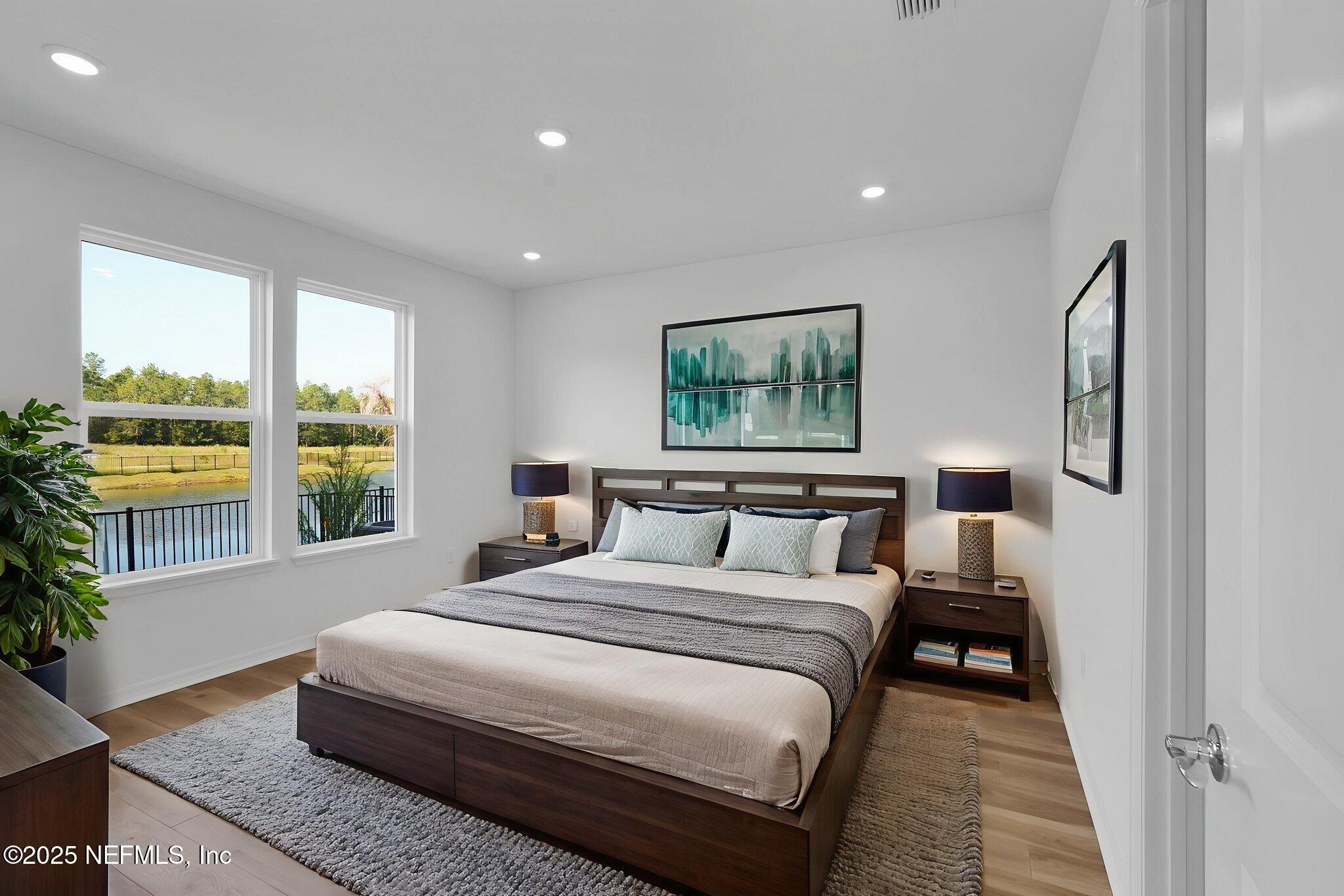 239 Fairlake Circle St. Augustine, FL 32092 - Photo 22 of 30 a bedroom with a large bed and a large window